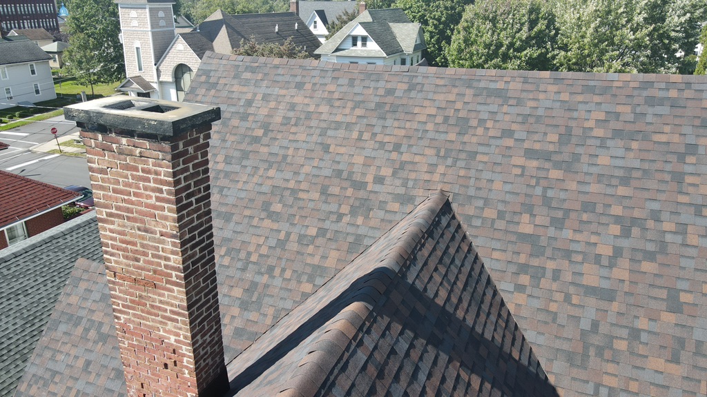Close-up of layered architectural shingles in warm tones